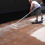 A man is cleaning the floor with a mop.