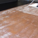 A floor with a wooden surface and a mop on it