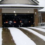 A garage with two cars parked in it