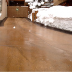 A wooden floor with snow on the ground