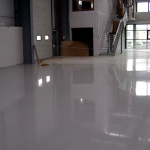 A white floor in a room with a fireplace.