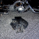 A motorcycle parked on the floor of a garage.