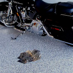 A motorcycle parked in front of a garage door.