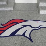 A large bronco logo on the floor of an office building.