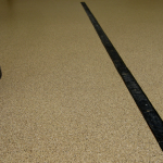 A black strip of rubber on the floor