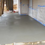 A cement floor with some tape on it