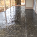 A patio with a large pattern of water on the floor.