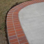 A concrete slab with brick border around it.