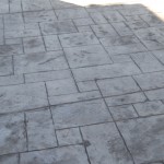 A close up of the concrete floor in an outdoor area.