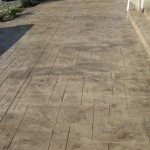 A walkway with a concrete floor and brick pattern.