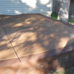 A concrete slab sitting in the middle of a yard.