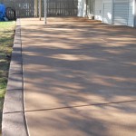 A patio with a concrete floor and a sidewalk.