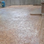 A patio with brick and stone pattern in the middle of it.