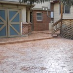 A patio with steps leading to the garage.