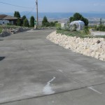 A road with cement and rocks on the side of it.