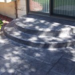 A patio with steps leading to the door.