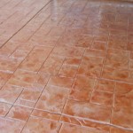 A tile floor with some brown tiles on it