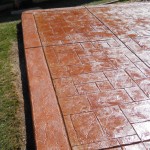 A close up of the concrete patio with brick pattern