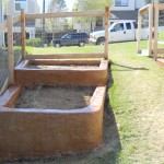 A couple of wooden boxes in the grass.