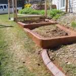 A garden bed with dirt and grass in it