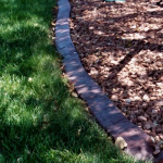 A close up of the edge of a garden path