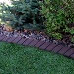 A garden with some grass and rocks