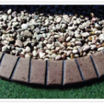 A pile of gravel sitting on top of grass.