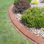 A garden with grass and rocks in the middle of it