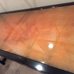 A television with some orange paint on it