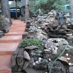 A walkway with steps leading to the side of a rock wall.