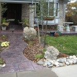 A walkway with a stone path and rock garden.