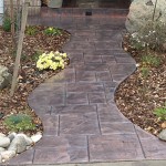 A walkway with brick and concrete is shown.