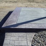 A concrete slab with a border and gravel area.