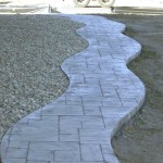 A walkway with a stone path and gravel.