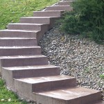 A stone staircase in the middle of a garden.