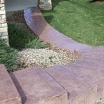 A brick walkway with steps leading to the front door.