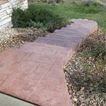 A walkway with brick steps and concrete curbs.