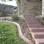 A brick walkway with steps leading to the front door.