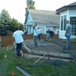 A group of men working on the patio.