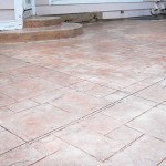 A patio with a tile floor and a door.