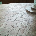 A patio with a stone floor and steps.