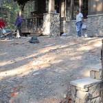 A group of people standing around in the dirt.