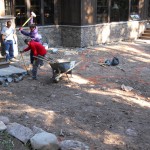 A group of people standing around in the dirt.