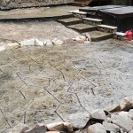 A patio with steps and rocks in the middle of it.