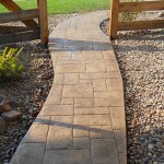 A walkway with stone and gravel in the middle of it.