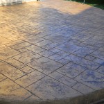 A patio with a large stone pattern on the ground.