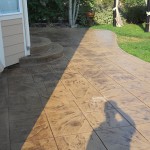 A patio with a curved walkway and steps.