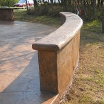 A concrete bench in the middle of a park.