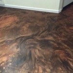 A floor that has been painted with brown and black colors.