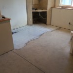 A kitchen with the floor being remodeled